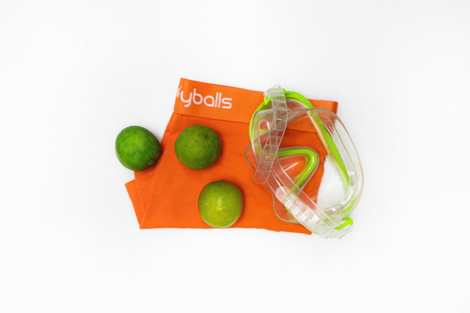 Folded boxer in colour Melon with limes and goggles.