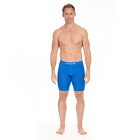 Man wearing blue swim shorts on a white background