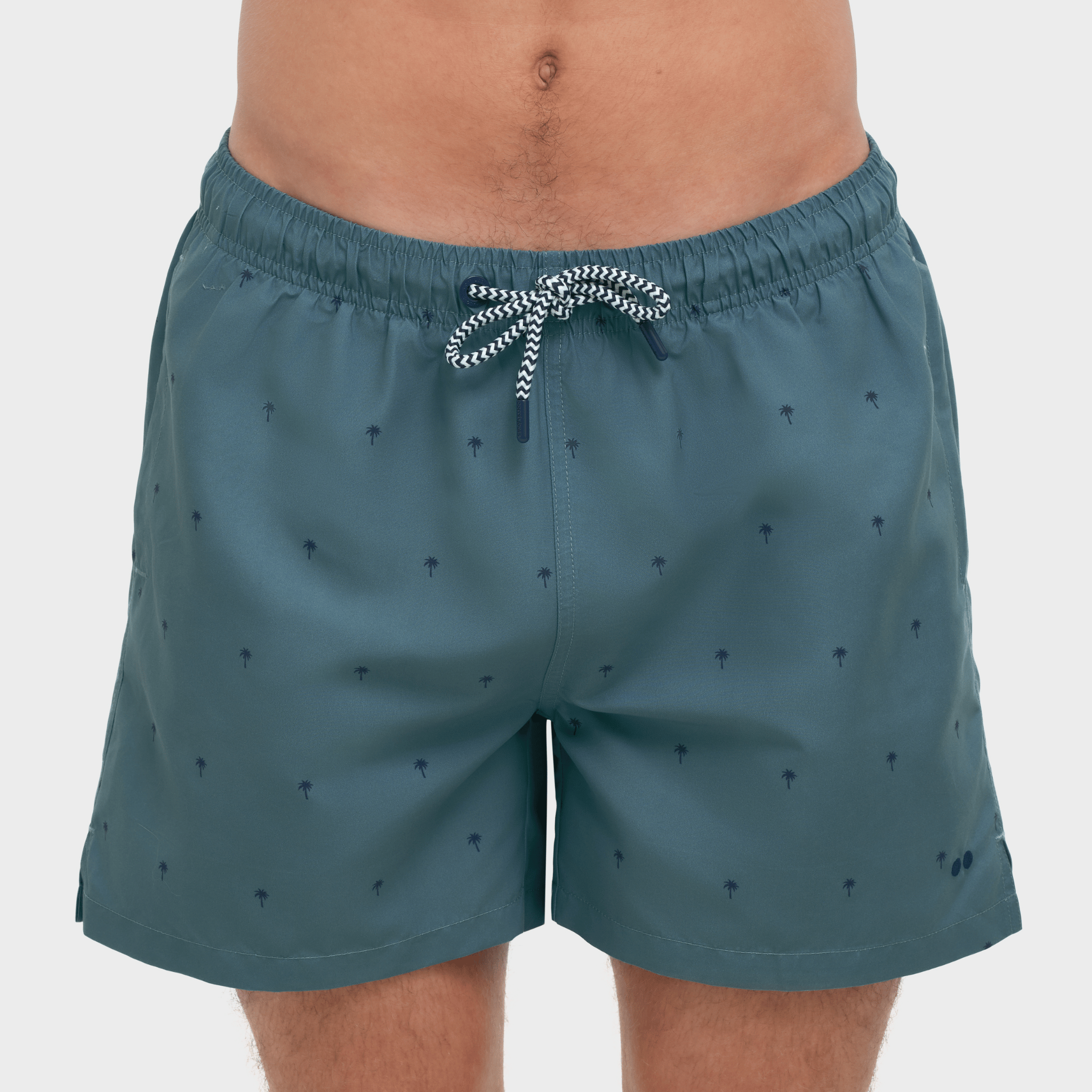 Teal swim shorts with a pattern on a plain background