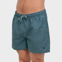 Teal swim shorts with a subtle pattern on a white background