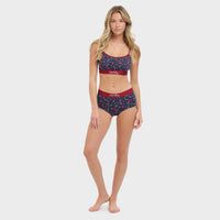 Woman wearing a navy and red patterned lingerie set on a white background