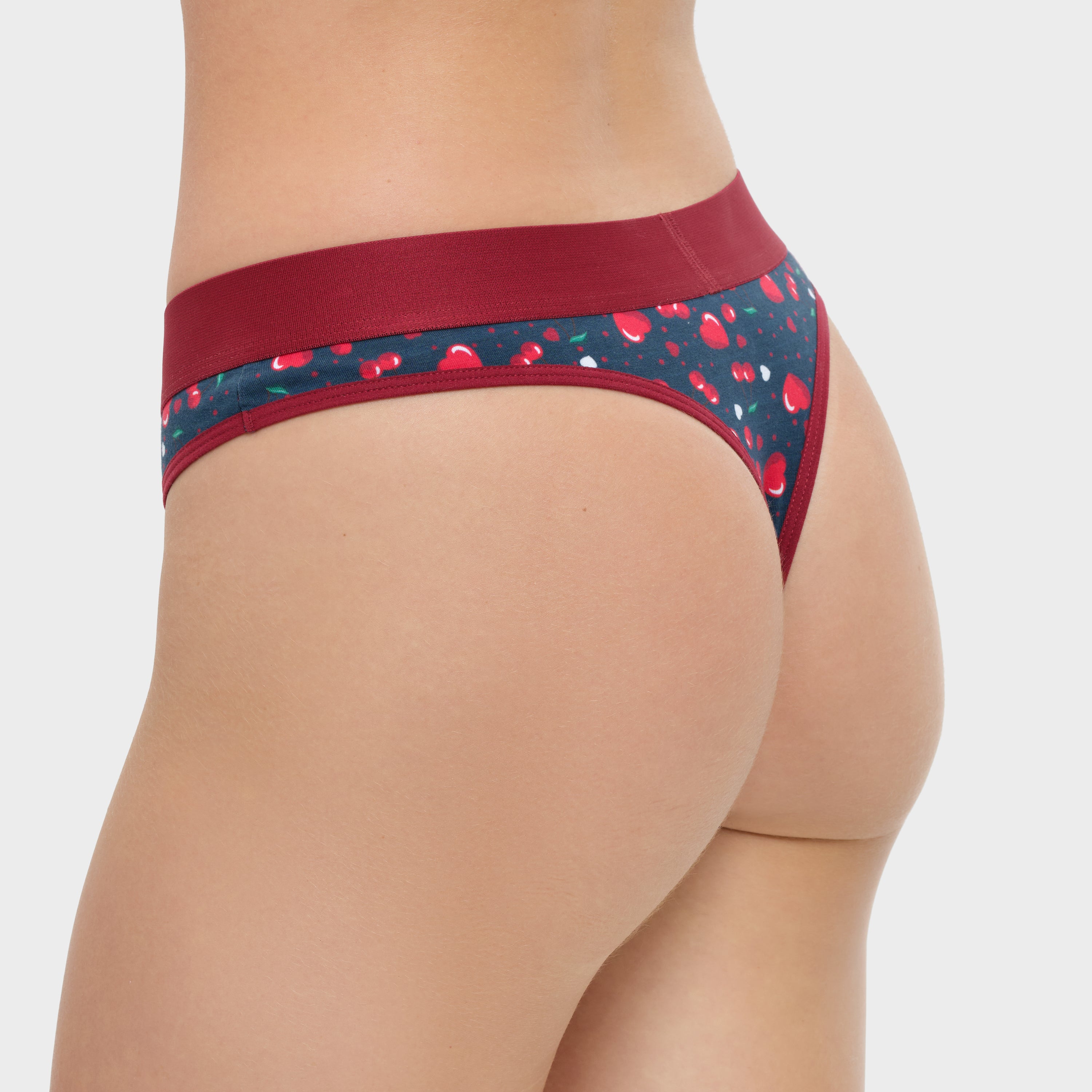 Patterned underwear with red waistband on a plain background