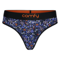 fit:string | quantity:1x | A pair of women's thong-style underwear by Comfy, featuring a dark blue and black Halloween-themed pattern with bones, ghosts, and jack-o'-lanterns, a black waistband with orange interior lining, and the brand name 'comfy' in orange on the front.