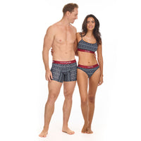 Man and woman wearing matching patterned underwear and bikini set on a white background